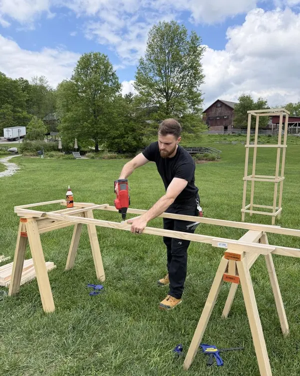Cade assembling a wooden trellis