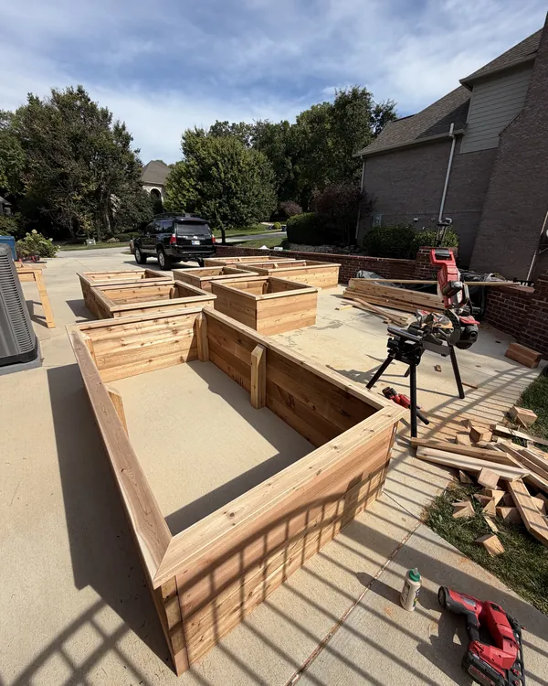 A long cedar raised garden bed being built
