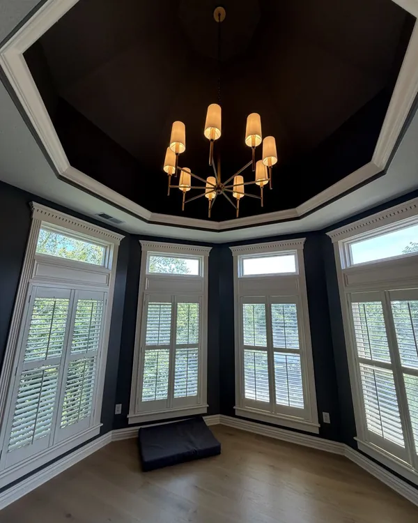 Statement chandelier installed in a turret window room