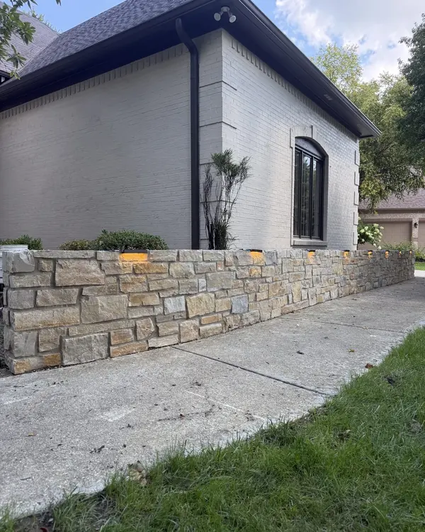 Accent lights built into a stone landscape wall