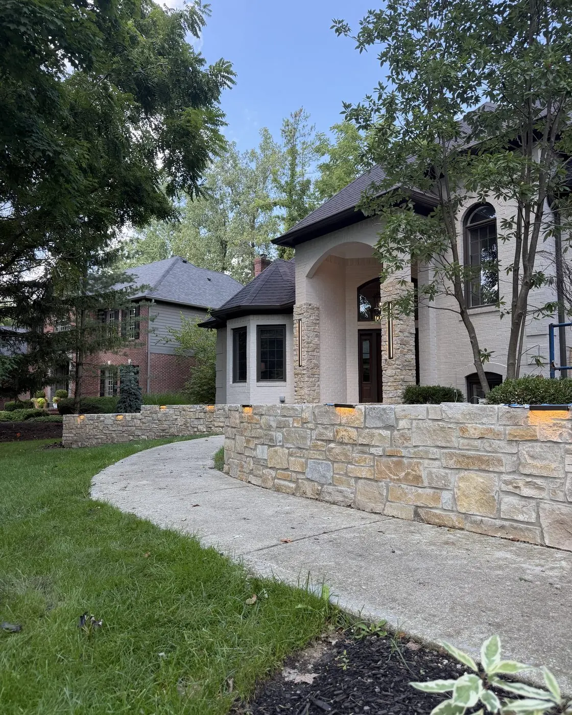 Stone wall accent lighting along a front walkway