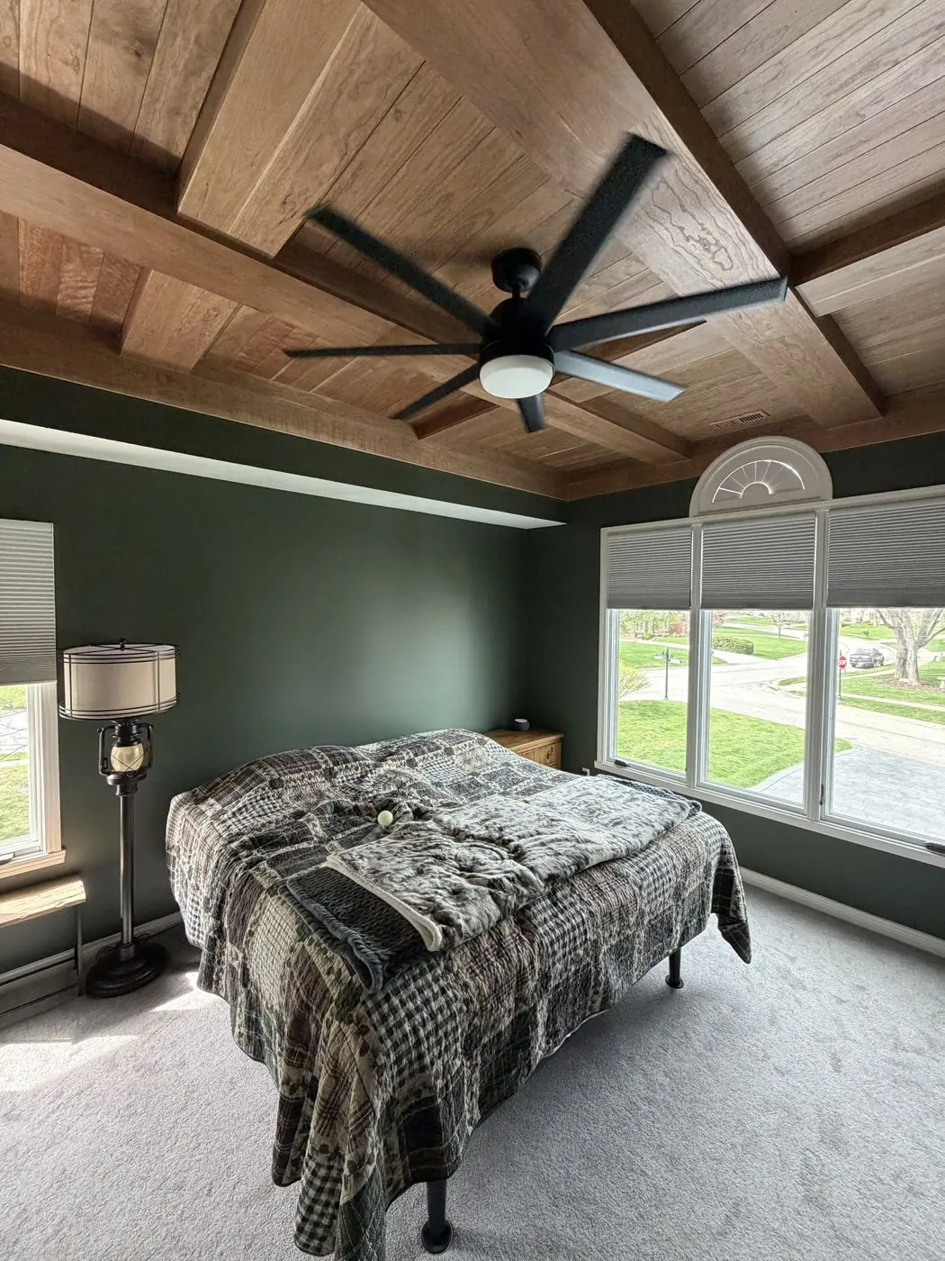 Ceiling fan installed on a wood-paneled bedroom ceiling